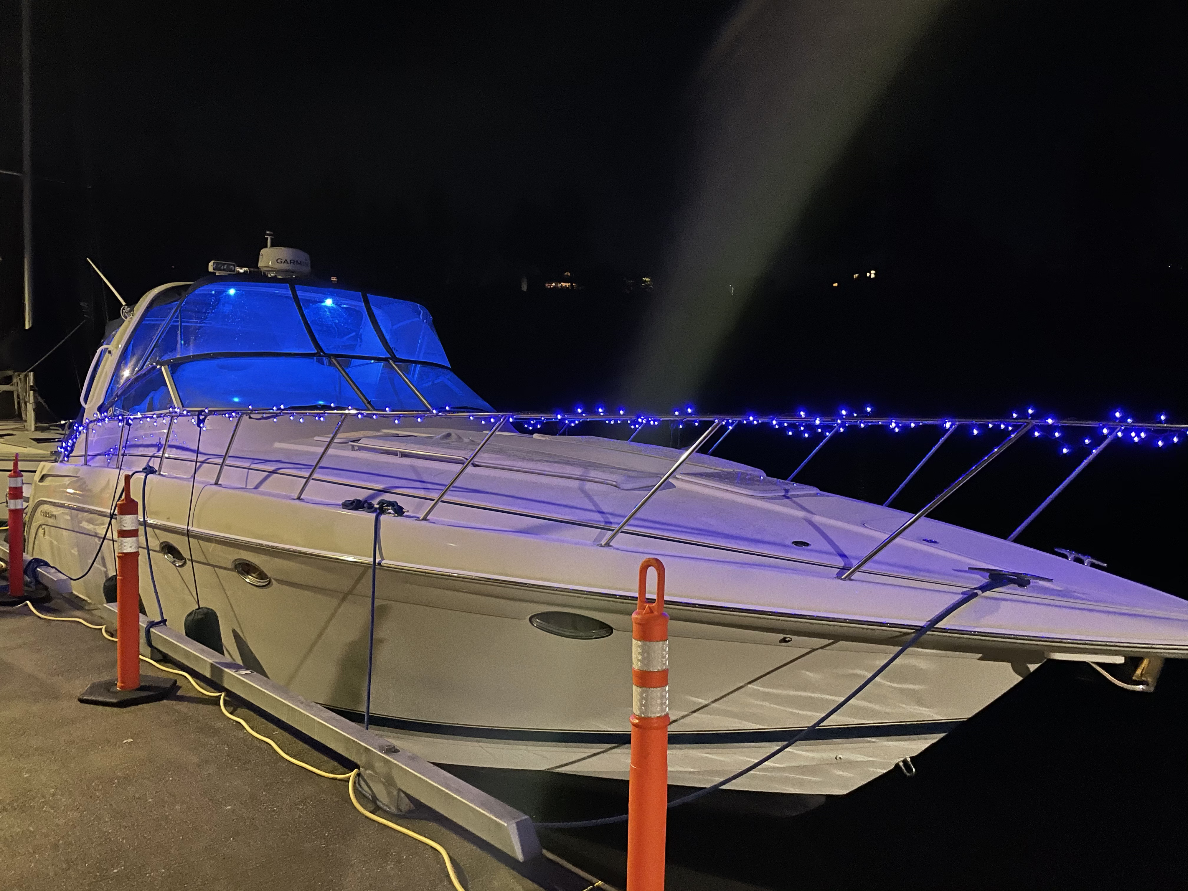 Slide: The Image of 2000 Formula 37 PC yacht with blue lights docked at night. - 40