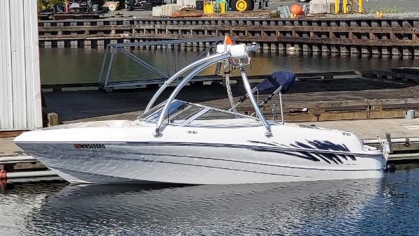 Slide: The Image of 1996 Four Winns 190 Horizon Bowrider boat docked in a marina. - 1