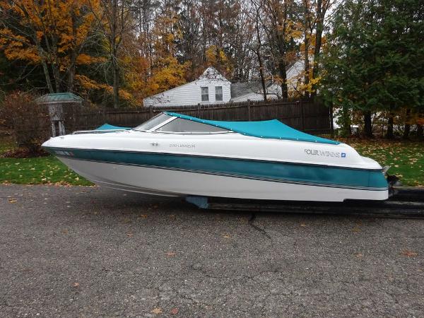 Slide: The Image of 1998 Four Winns 200 Horizon boat with teal cover on trailer. - 0