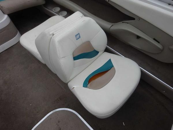Slide: The Image of 1998 Four Winns 200 Horizon boat interior with worn white seats. - 1