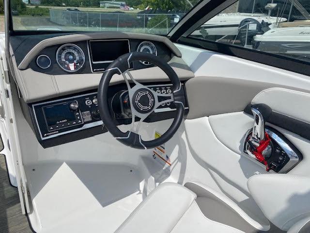 Slide: The Image of 2023 Four Winns H260 boat cockpit with steering wheel and control panel. - 14