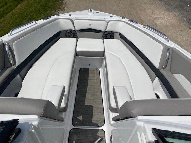 Slide: The Image of 2023 Four Winns H260 boat interior with white and gray seating. - 17
