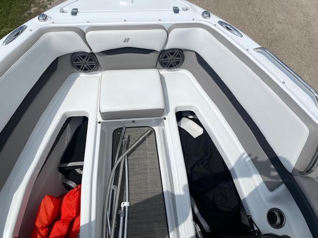 Slide: The Image of 2023 Four Winns H260 boat interior with seating and storage compartments. - 18
