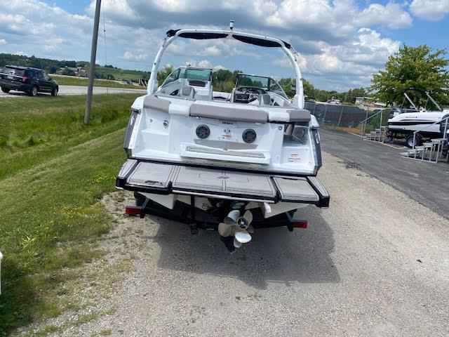 Slide: The Image of 2023 Four Winns H260 boat rear view with swim platform and outboard motor. - 3