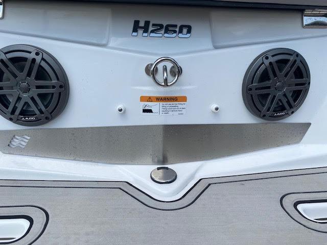 Slide: The Image of 2023 Four Winns H260 boat rear speakers and warning label. - 4