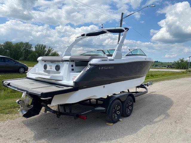 Slide: The Image of 2023 Four Winns H260 boat on a trailer, ready for transport. - 6