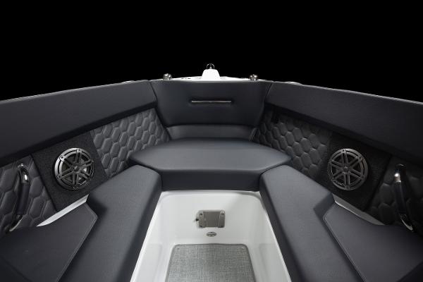 Slide: The Image of 2023 Four Winns H2 OB boat interior with black cushioned seating and built-in speakers. - 13