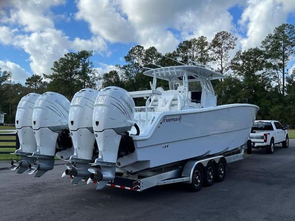 Slide: The Image of 2022 Freeman 37 VH boat with four outboard engines on a trailer. - 1