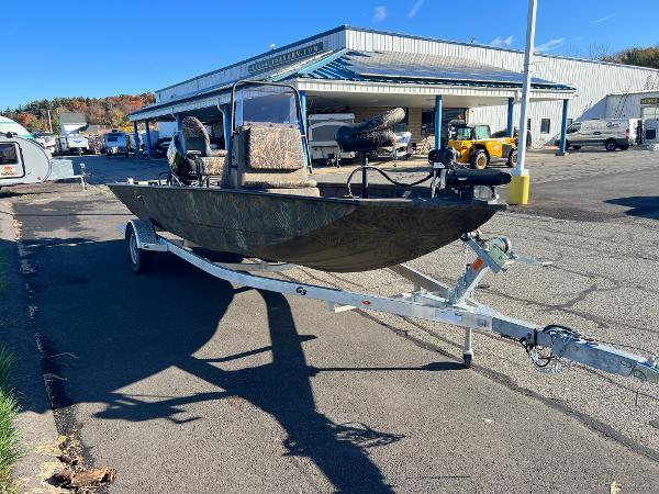 Slide: The Image of 2021 G3 Bay 20 DLX boat on a trailer in a parking lot. - 2