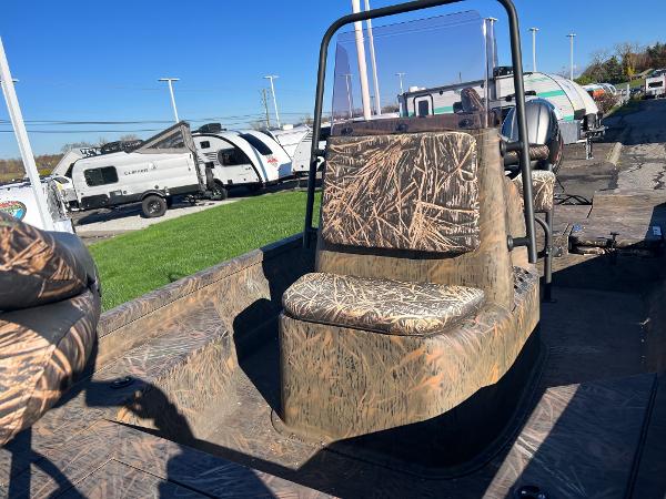 Slide: The Image of 2021 G3 Bay 20 DLX boat with camo seats and windshield, parked near RVs. - 7
