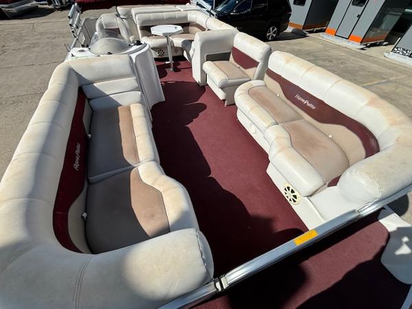 Slide: The Image of 2002 Godfrey Aqua Patio boat with spacious seating and maroon carpet. - 6