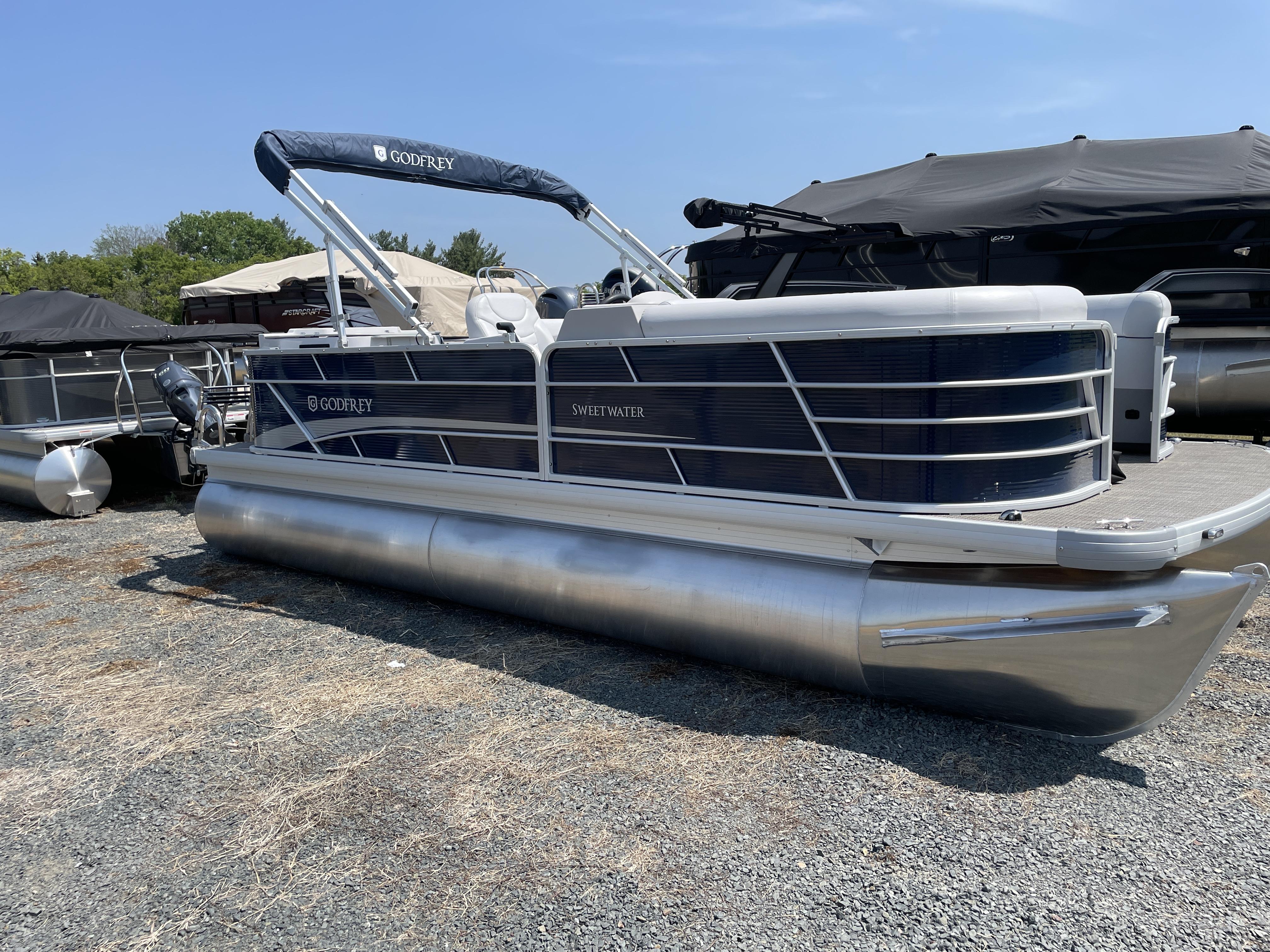 Slide: The Image of 2024 Godfrey SW2186FS pontoon boat on display outdoors. - 8
