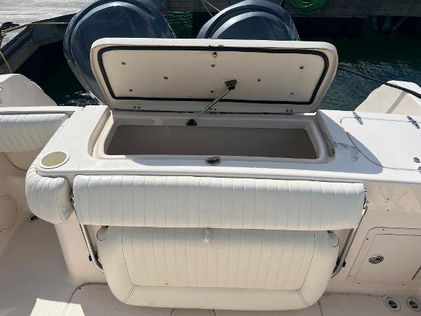 Slide: The Image of Open storage compartment on 2005 Grady-White 283 RELEASE boat, docked with twin engines. - 6