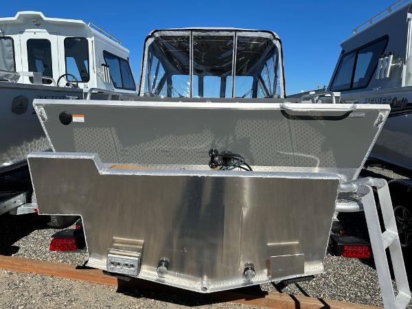 Slide: The Image of 2024 Hewescraft 200 Pro-V boat rear view in a marina. - 2