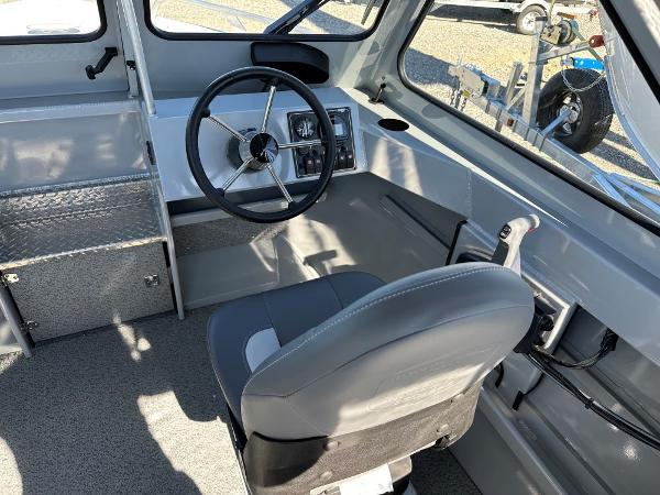 Slide: The Image of 2024 Hewescraft 200 Pro-V boat interior with steering wheel and captain's seat. - 5