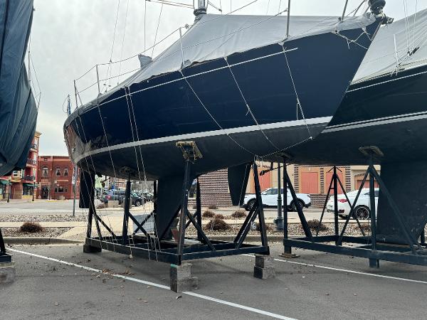 Slide: The Image of 1986 J Boats J30 sailboat on a stand in a parking lot. - 1