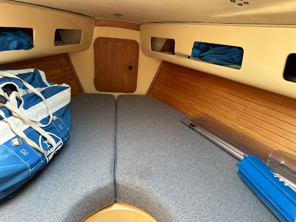 Slide: The Image of Interior cabin of a 1986 J Boats J30 sailboat with storage and cushions. - 5