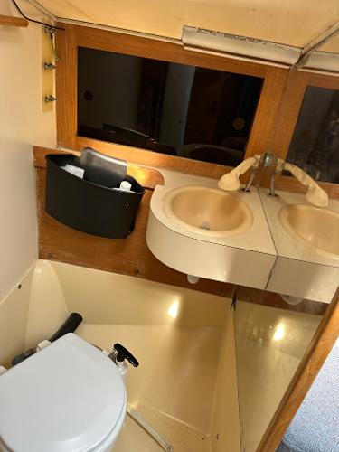 Slide: The Image of 1986 J Boats J30 sailboat bathroom with sink, mirror, and toilet. - 6
