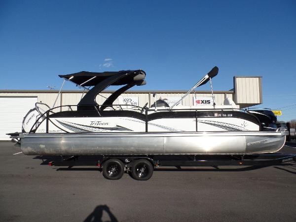 Slide: The Image of 2017 JC Sporttoon 28TT pontoon boat on a trailer in a parking lot. - 1