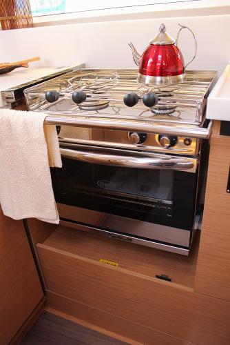 Slide: The Image of Modern kitchen stove with red kettle in 2025 Jeanneau Sun Odyssey 440 yacht. - 15