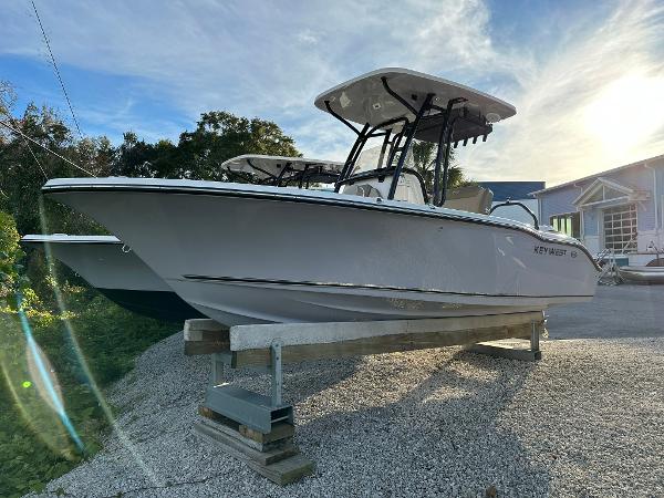 Slide: The Image of 2024 Key West 219 FS boat on display, parked on gravel under a clear sky. - 1