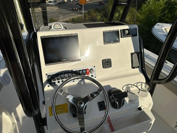 Slide: The Image of 2024 Key West 219 FS boat dashboard with steering wheel and electronic controls. - 7