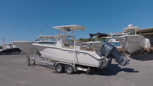 Slide: The Image of 2018 Key West 239FS boat on trailer in marina. - 1