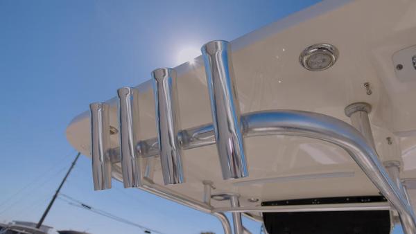 Slide: The Image of 2018 Key West 239FS boat rod holders and T-top under clear sky. - 2