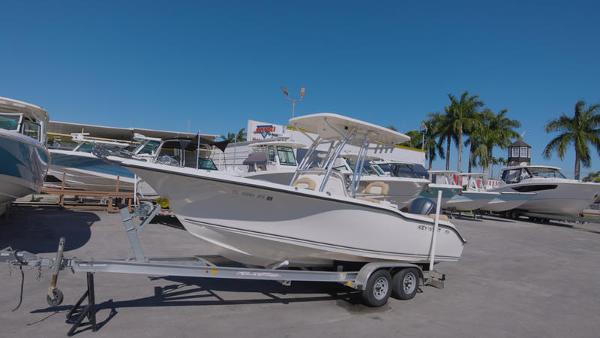 Slide: The Image of 2018 Key West 239FS boat on a trailer in a marina. - 4