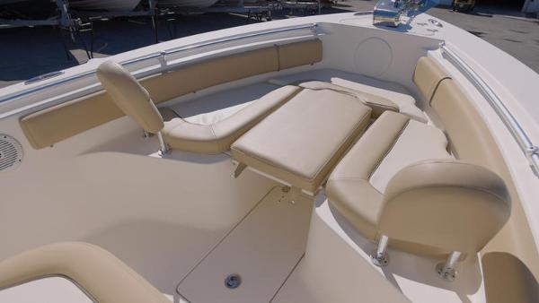 Slide: The Image of 2018 Key West 239FS boat interior with beige seating and cushions. - 5