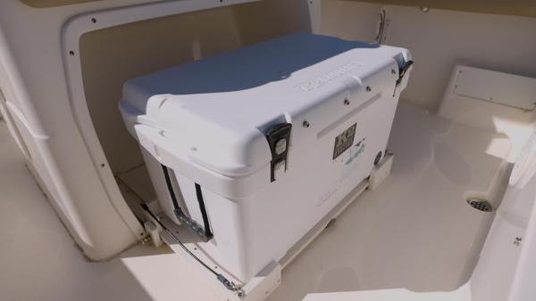 Slide: The Image of 2018 Key West 239FS boat with a secured cooler in the storage compartment. - 9