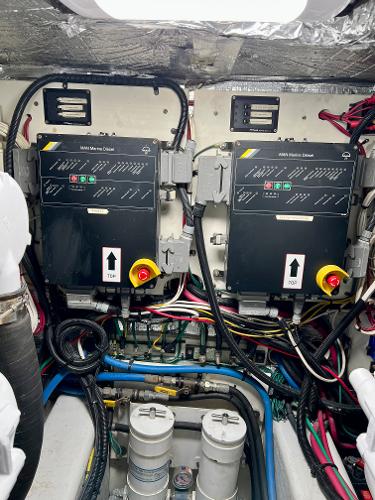 Slide: The Image of Engine room of a 2004 Legacy Downeast boat with electrical panels and wiring. - 29