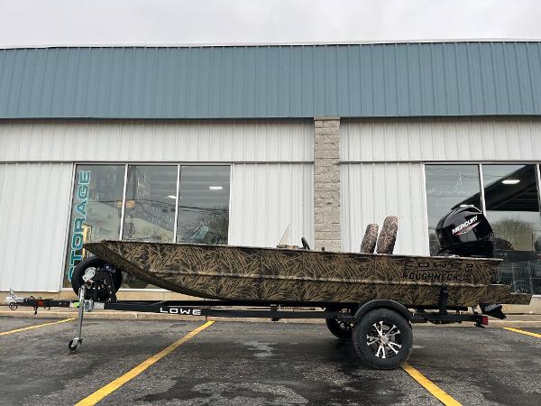 Slide: The Image of 2024 Lowe Roughneck RX1660 SC boat on trailer, parked outside a storage facility. - 0