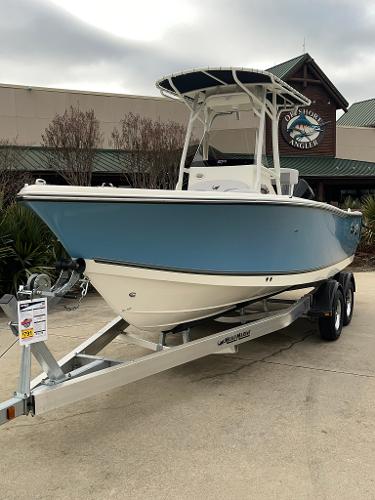 Slide: The Image of 2024 Mako 214 CC center console boat on a trailer outside a dealership. - 0