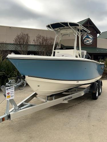Slide: The Image of 2024 Mako 214 CC boat on a trailer outside a dealership. - 1