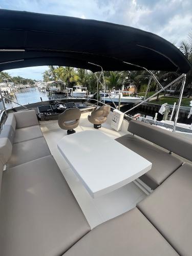 Slide: The Image of 2017 Marquis 500 Sport Yacht with spacious seating and table on deck. - 12