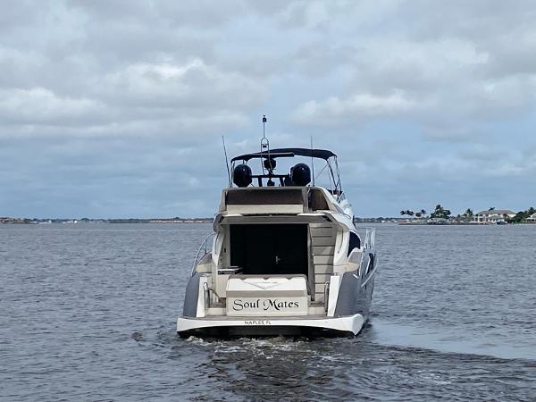 Slide: The Image of 2017 Marquis 500 Sport Yacht Soul Mates cruising on a calm waterway. - 3