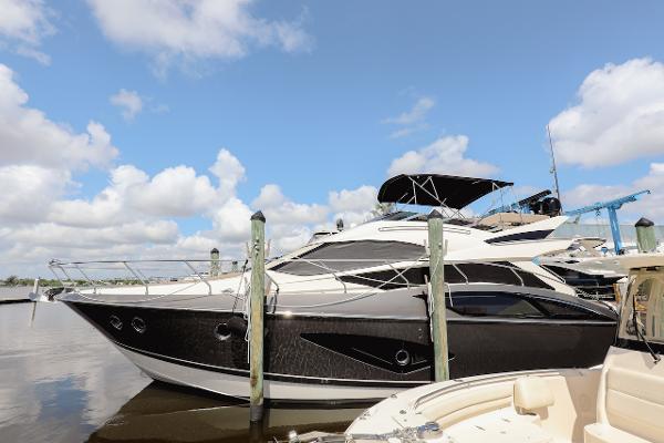 Slide: The Image of 2017 Marquis 500 Sport Yacht docked at marina under blue sky. - 8