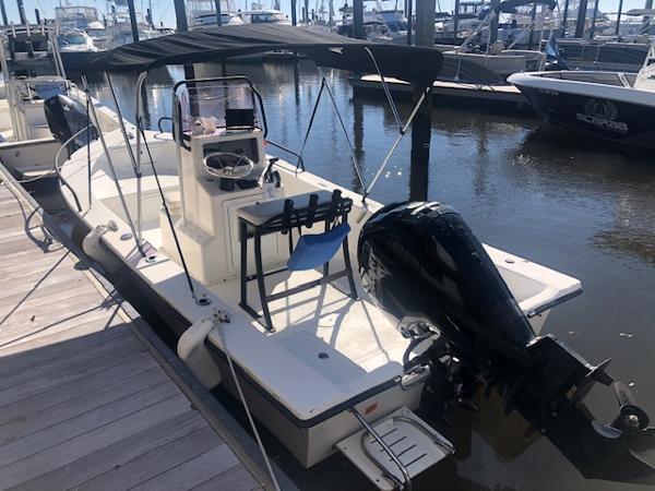 Slide: The Image of 2021 May-Craft 1800 Skiff boat docked at marina with canopy and outboard motor. - 3