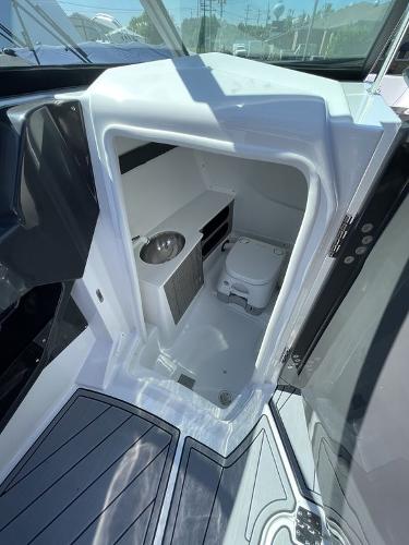 Slide: The Image of 2023 Monterey 278SS boat interior with compact bathroom and toilet. - 10