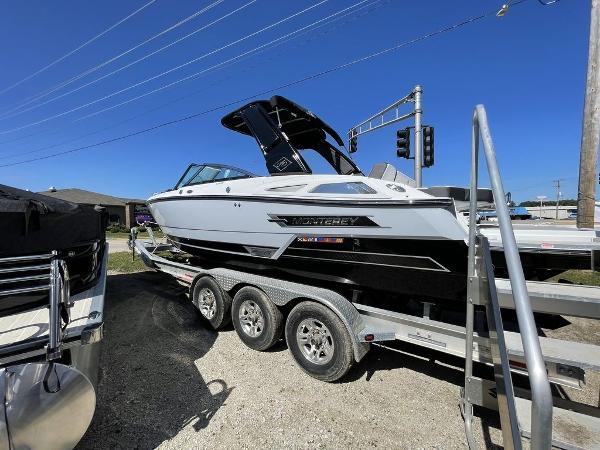 Slide: The Image of 2023 Monterey 278SS boat on a trailer under a clear blue sky. - 12