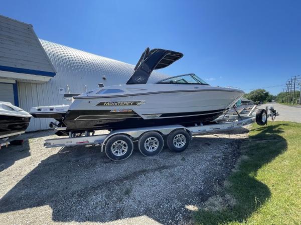 Slide: The Image of 2023 Monterey 278SS boat on a trailer outside a building. - 2
