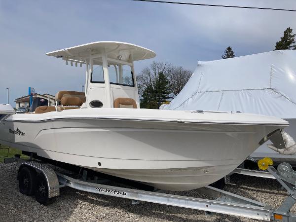 Slide: The Image of 2023 NauticStar 24 Legacy boat on a trailer, side view. - 0