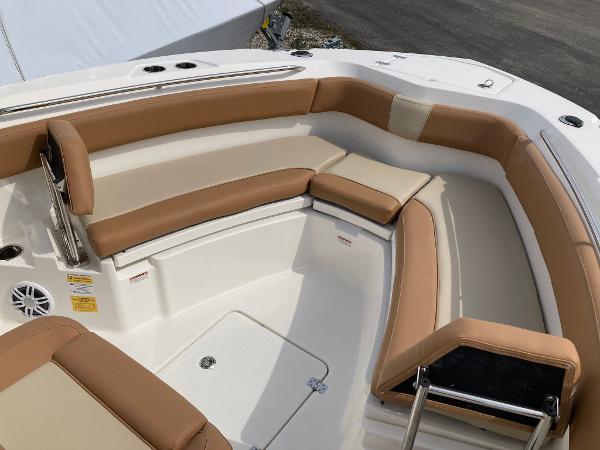 Slide: The Image of 2023 NauticStar 24 Legacy boat with tan and white cushioned seating. - 10