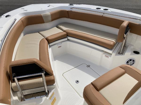 Slide: The Image of 2023 NauticStar 24 Legacy boat interior with tan and cream seating. - 12