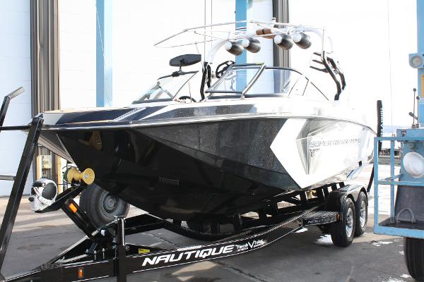 Slide: The Image of 2017 Nautique Super Air G23 boat on trailer, sleek design, black and white color scheme. - 0