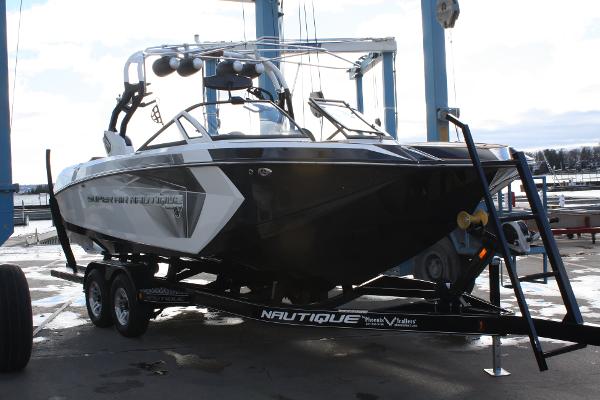 Slide: The Image of 2017 Nautique Super Air G23 boat on trailer at marina. - 1
