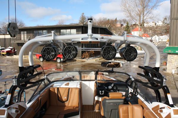 Slide: The Image of 2017 Nautique Super Air G23 boat interior with speakers and brown seating. - 12