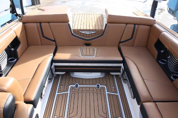 Slide: The Image of 2017 Nautique Super Air G23 interior with tan leather seating and teak flooring. - 14
