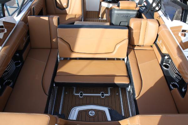 Slide: The Image of 2017 Nautique Super Air G23 interior with tan leather seating and wood accents. - 15